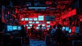 A team of hackers work on multiple computer screens in a dimly lit room. The room is decorated with red and blue lighting creating Royalty Free Stock Photo