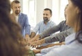 Team of happy business people stacking their hands during work meeting in office Royalty Free Stock Photo