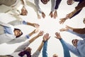 Team of happy business people standing in circle, putting hands together and smiling Royalty Free Stock Photo