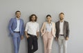 Team of happy confident business people in office wear standing in studio and smiling Royalty Free Stock Photo