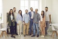 Team of happy confident young and mature business people standing in office and smiling Royalty Free Stock Photo