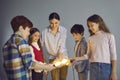 Team of happy creative children and teacher holding and joining bright idea light bulbs Royalty Free Stock Photo