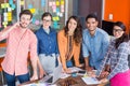 Team of happy graphic designers standing at table Royalty Free Stock Photo