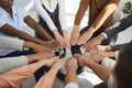 Team of happy multiethnic men and women together putting their hands in a circle