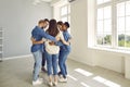 Team of happy multiracial business people standing in office and hugging each other Royalty Free Stock Photo