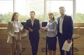 Team of happy successful business men and women standing together by office window Royalty Free Stock Photo