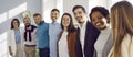 Multiracial team of happy young business people hugging and smiling in their office Royalty Free Stock Photo