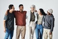 Team of happy united young business people hugging each other. Diverse mixed race group of men and women standing in row Royalty Free Stock Photo