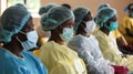 A team of healthcare workers conduct a training session on control and prevention protocols. They are equipping their Royalty Free Stock Photo