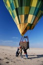 Team of helpers ensures a safe landing of a hot air balloon