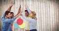 Team highfiving against colourful ven diagram and blurry wood panel Royalty Free Stock Photo