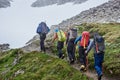 Team of hikers walking on mountain path. Royalty Free Stock Photo