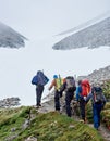 Team of hikers walking on mountain path. Royalty Free Stock Photo