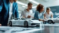 A group of people are working on a model car AIG41 Royalty Free Stock Photo