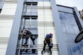 Team of industrial climbers at work, they are washing building f Royalty Free Stock Photo