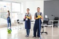 Team of janitors cleaning office