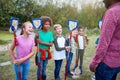 Team Leader And Group Of Children On Outdoor Activity Camp Catching Pond Wildlife