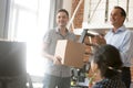 Team leader introducing new employee holding box on first day Royalty Free Stock Photo