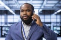Team leader overseeing operations in modern data center, coordinating tasks