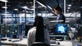 Team leader supervising technicians in server room using AI Royalty Free Stock Photo