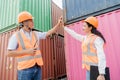 Team of logistics engineers, men and women in reflective jackets stand outside large commercial port. Containers in Export-Import