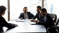 Team of male employers laughing at job interview with male candidate.