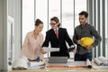 Team of male and female engineers and architects, working team, meeting, discussing construction and drawing construction plans, Royalty Free Stock Photo