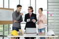 Team of male and female engineers and architects, working team, meeting, discussing construction and drawing construction plans, Royalty Free Stock Photo