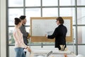 Team of male and female engineers and architects, working team, meeting, discussing construction and drawing construction plans, Royalty Free Stock Photo