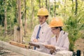 Team of male and female engineers and architects, working team, meeting, discussing construction, and inspecting the outdoor Royalty Free Stock Photo