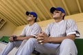 Team-Mates Sitting In Dugout Royalty Free Stock Photo