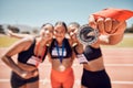 Team, medal winner and sports success on stadium field for marathon copetition. Athlete women, trophy for fitness and Royalty Free Stock Photo