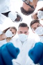 Team of medical doctors looking down at patient Royalty Free Stock Photo