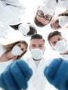 Team of medical doctors looking down at patient Royalty Free Stock Photo