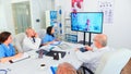 Team of medical staff during video conference with doctor in hospital Royalty Free Stock Photo