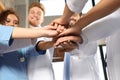 Team of medical workers holding hands together in hispital. Unity concept Royalty Free Stock Photo