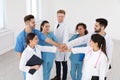 Team of medical workers holding hands together in hospital Royalty Free Stock Photo