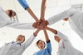 Team of medical workers holding hands together in hospital. Unity concept Royalty Free Stock Photo