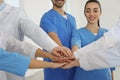 Team of medical workers holding hands together indoors Royalty Free Stock Photo