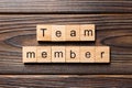 Team member word written on wood block. Team member text on table, concept