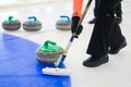 Team members play in curling