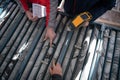 Team of mining  workers measuring drilled rock core Royalty Free Stock Photo