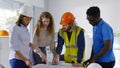 Team of multiethnic architects working on construction plans in meeting room. Royalty Free Stock Photo