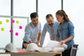 Team of multiethnic architects working on construction plans in meeting room. Engineers discussing on project in office Royalty Free Stock Photo