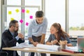 Team of multiethnic architects working on construction plans in meeting room. Engineers discussing on project in office Royalty Free Stock Photo