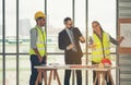 Team of multiethnic architects working on construction plans in meeting room. Engineers discussing on project in office. Mature Royalty Free Stock Photo