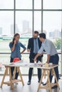 Team of multiethnic architects working on construction plans in meeting room. Engineers discussing on project in office. Mature Royalty Free Stock Photo