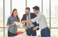 Team of multiethnic architects working on construction plans in meeting room. Engineers discussing on project in office. Mature Royalty Free Stock Photo