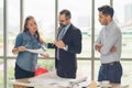 Team of multiethnic architects working on construction plans in meeting room. Engineers discussing on project in office. Mature Royalty Free Stock Photo