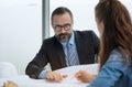 Team of multiethnic architects working on construction plans in meeting room. Engineers discussing on project in office Royalty Free Stock Photo